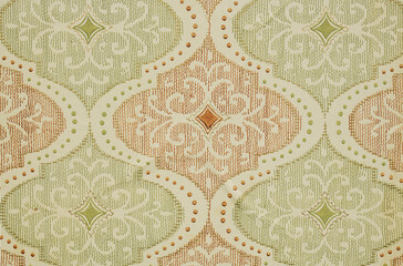 Old wallpaper on the wall. Old wallpaper for texture or background.