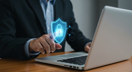 Businessman using a laptop with a digital security shield overlay, highlighting online protection.
