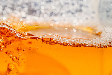 Close up bright orange Oil or beer splash texture and nature waves, Beautiful waves curve and little bubbles smooth for graphic design and background, Oil Bubbles, Soft beer bubbles, Selective focus