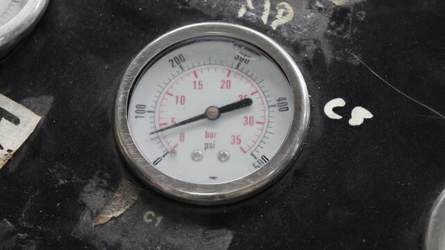 Pressure gauge or manometer indicates increased pressure. mechanical installation air pressure manometer.