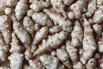 Fresh Jerusalem Artichokes on a Wooden Cutting Board in Natural Lighting