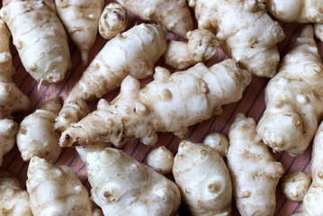Fresh Jerusalem Artichokes on a Wooden Cutting Board in Natural Lighting