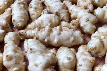 Fresh Jerusalem Artichokes on a Wooden Cutting Board in Natural Lighting