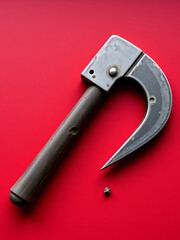 An old crowbar on a red background