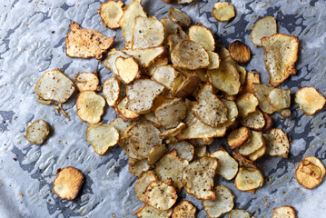 Baked Root of Jerusalem artichokes Vegetable Chips on Parchment Paper