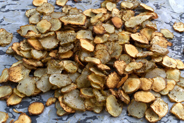 Baked Root of Jerusalem artichokes Vegetable Chips on Parchment Paper