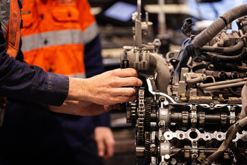 Male mechanics hand working on mining fleet vehicles engine