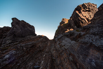 Fototapeta premium mountains and rocks with fresh green grass on the shore of the Arctic Ocean without people