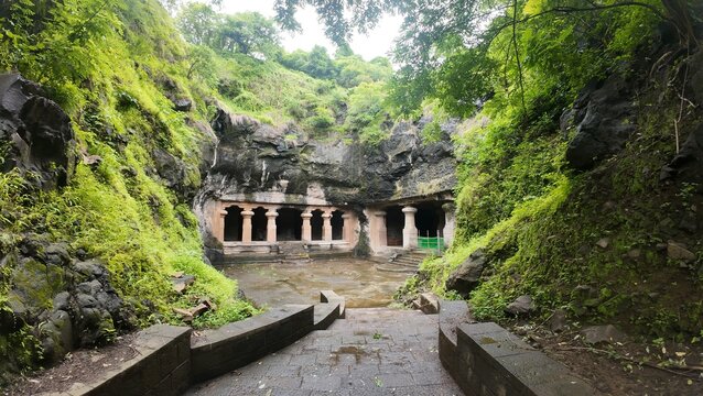 Majestic Exterior of Elephanta Caves with Massive Columns in Monsoon Greenery