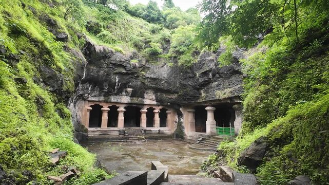 Majestic Exterior of Elephanta Caves with Massive Columns in Monsoon Greenery