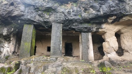 Majestic Exterior of Elephanta Caves with Massive Columns in Monsoon Greenery