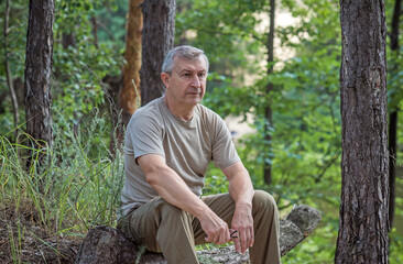 Pensive European senior man, emotional portrait of reflection and life challenges. Emotive portrait of a 55&ndash;65 year old man outdoors