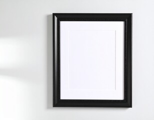Fototapeta premium Elegant Black Picture Frame with White Mat on White Wall, Shadow Detail