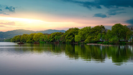 Beautiful Sunset Over Calm Lake With Lush Green Trees