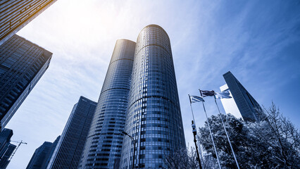 Naklejka premium Modern Urban Skyscrapers Against Clear Blue Sky