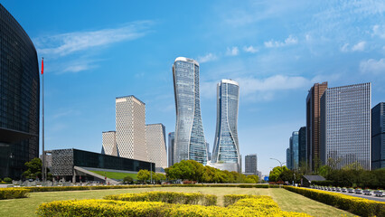 Modern cityscape with tall skyscrapers under blue sky