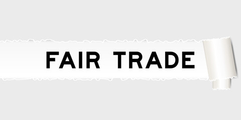 Ripped gray paper background that have word fair trade under torn part