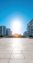 Empty plaza between modern buildings under bright sunlight
