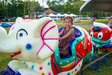 Little girl enjoy outdoor amusement city park festival