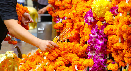 Marigold flower garlands offered for worship at the Erawan Shrine in Bangkok, Thailand.