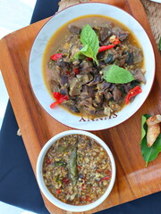 Spicy Thai stir-fry with chicken offal, cooked with garlic, chili, and fresh holy basil leaves, delivering a rich, aromatic, and flavorful dish perfect with steamed rice.