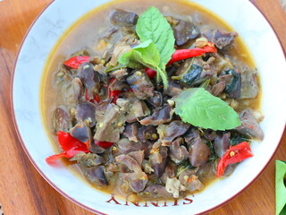 Spicy Thai stir-fry with chicken offal, cooked with garlic, chili, and fresh holy basil leaves, delivering a rich, aromatic, and flavorful dish perfect with steamed rice.