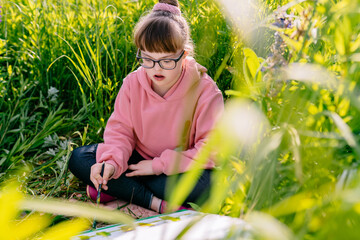 Child with Down Syndrome Painting Outdoors