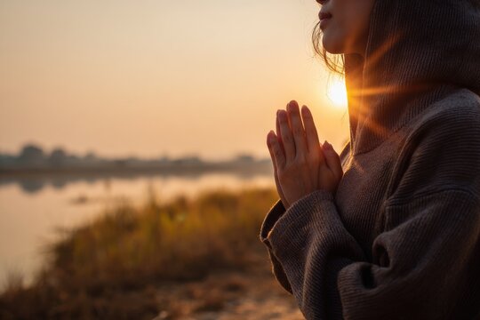 Woman in prayer, sunrise - Powered by Adobe