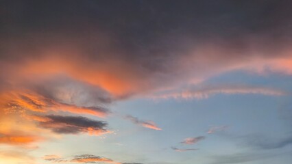 sky in the orange and blue colors effect of light pastel colored of sunset clouds cloud on the sunset sky background with a pastel color