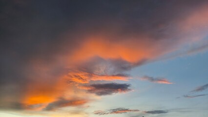 sky in the orange and blue colors effect of light pastel colored of sunset clouds cloud on the sunset sky background with a pastel color
