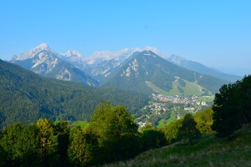 View of Pišnica valley and mountains in Julian alps with the town of Kranjska Gora bellow in Gorenjska, Slovenia