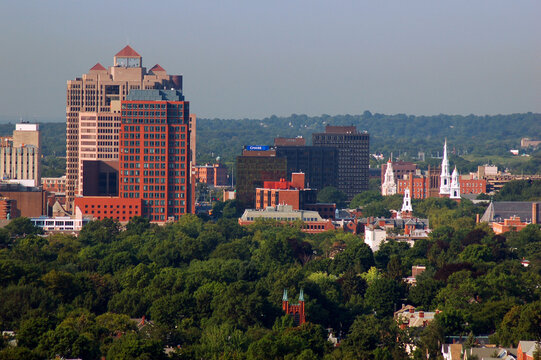 The steeples of the churches rise near the office buildings and high rises of New Haven Connecticut