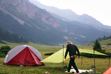 a young man camping in the mountains