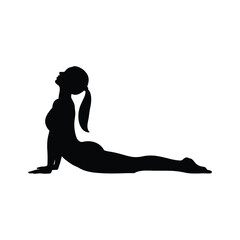 Silhouette of a woman performing a cobra pose in yoga