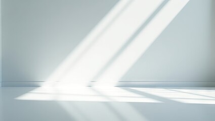 Sunlight casts dramatic shadows on a white room.