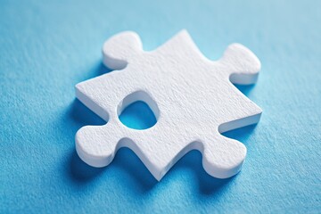 Close-up of a single white jigsaw puzzle piece on a light blue background