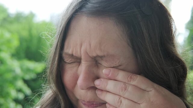 50 year old female with eye irritation, speck, Mature woman with tired eyes, optical discomfort, blurry vision problems, tired look, poor eyesight, aging, health care, close up view