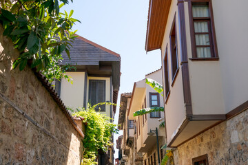 Narrow alleyway with a stone wall and a row of houses