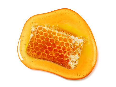 Golden honeycomb pieces dripping with honey. Honeycomb Isolated. Honeycomb with honey honeycomb dessert cream.