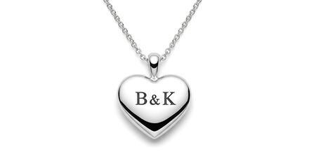 Centered of heart-shaped pendant necklace engraved with the initials B & K, clean and white background