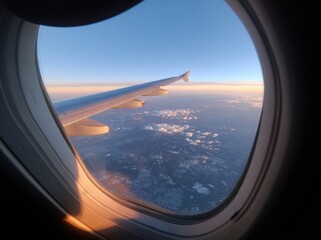 Airplane window view of earth at sunset