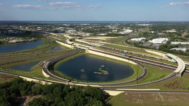 Aerial View Of Cars Driving Through Highway Interchange With Lakes In Sanford City, Florida, USA.