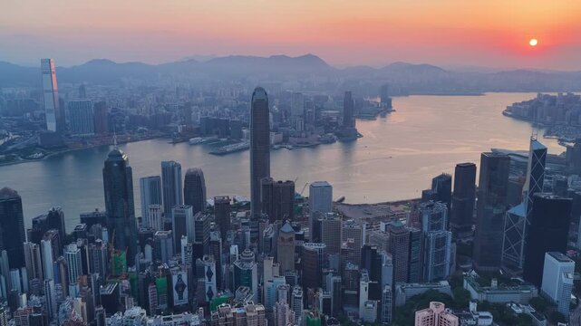 Cinematic Aerial view of Hong Kong skyline at golden hour featuring IFC and ICC towers, symbolizing global finance, modern architecture, and a vibrant hub for travel and business