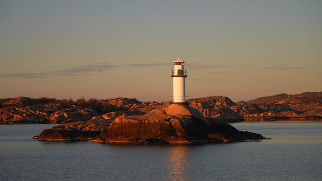 Lighthouse Stromstad Fjord Ursholmen Sweden ferry boat ride land of the Svea Sverige calm sea ocean water late arctic afternoon sunset Str&ouml;mstad Nordkoster enchanting coastal beauty circle motion
