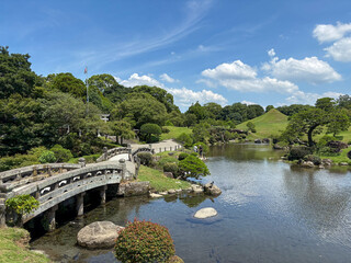 Fototapeta premium Stone Bridge and Pond at Suizenji Jojuen Garden