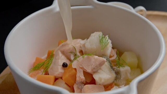 Traditional fish soup in a plate. Ukha. on a dark background. selective focus.