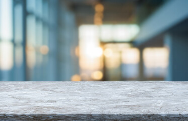 Modern marble countertop with abstract blurred background of a office during sunset