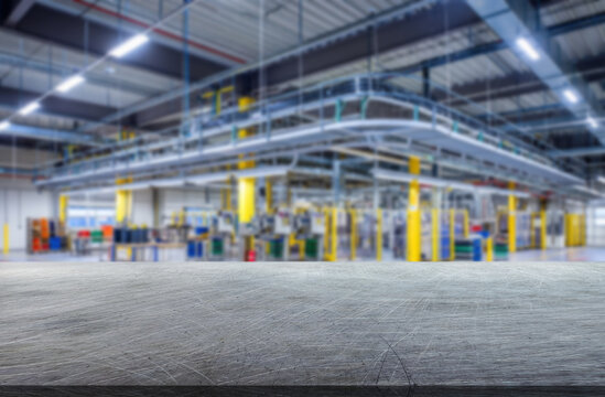 Blur background of a Industrial setting featuring a spacious manufacturing facility with organized workstations and equipment and metal surface with scratches