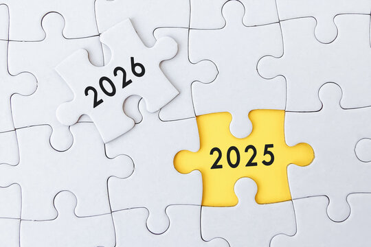 pieces of jigsaw puzzle with word 2026 and 2025