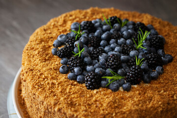 Delicious dessert with berry topping decorated on a rustic wooden table